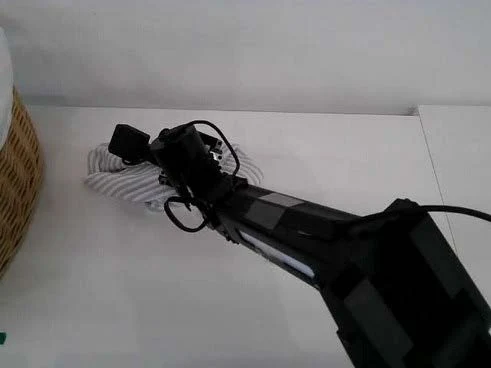 Dual-arm robot folding a white towel on a table, real capture frame